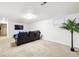 Basement features large carpeted area, a sofa and a TV at 8460 Corona St, Denver, CO 80229