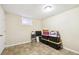 Unfinished basement space with neutral tones and tile flooring at 8460 Corona St, Denver, CO 80229