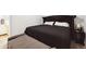 Close up on bedroom featuring a black bed frame with studded accents and a gray bench at 8460 Corona St, Denver, CO 80229