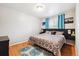Cozy bedroom with wood floors, a queen sized bed and closet at 8460 Corona St, Denver, CO 80229