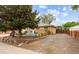 Ranch-style home featuring a nicely landscaped front yard, brick accents, rock details, and outdoor seating area at 8460 Corona St, Denver, CO 80229