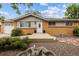 Charming brick ranch home with a well-kept front yard and a decorative fountain feature at 8460 Corona St, Denver, CO 80229