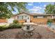 Charming ranch-style home boasts a well-maintained front yard with a decorative water feature and manicured landscaping at 8460 Corona St, Denver, CO 80229