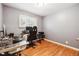 Office space features wood floors, grey walls and large window at 8460 Corona St, Denver, CO 80229