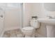 A bathroom with a sink and shower boasts clean lines, functional design, and a bright, inviting ambiance at 3055 Clermont St, Denver, CO 80207