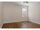 Inviting bedroom with hardwood floors, white trim, and a window offering natural light for a cozy and comfortable atmosphere at 3055 Clermont St, Denver, CO 80207
