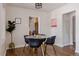 Well-lit dining room with a round glass table and modern black chairs, perfect for gatherings at 3055 Clermont St, Denver, CO 80207