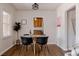 Bright dining area with hardwood floors features contemporary furniture and a charming aesthetic at 3055 Clermont St, Denver, CO 80207