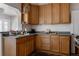 Functional kitchen features wood cabinets, modern appliances, and ample counter space at 3055 Clermont St, Denver, CO 80207