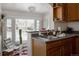 Bright kitchen features a modern sink, cabinets, and a large window overlooking the neighborhood at 3055 Clermont St, Denver, CO 80207