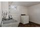 Practical laundry room with vintage washer/dryer, utility sink, and a bright window, providing a functional space for chores at 3055 Clermont St, Denver, CO 80207