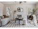 Inviting living room featuring a decorative fireplace, modern ceiling fan, and plenty of natural light at 3055 Clermont St, Denver, CO 80207