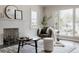 Sun-drenched living room with a cozy chair, stylish decor, and a serene atmosphere for relaxation at 3055 Clermont St, Denver, CO 80207