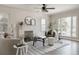Bright living room featuring a fireplace, modern furnishings, and large windows that let in plenty of natural light at 3055 Clermont St, Denver, CO 80207