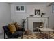 Inviting living room with a charming brick fireplace, modern decor, and ample natural light for a cozy and welcoming ambiance at 3055 Clermont St, Denver, CO 80207