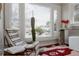 Relaxing sunroom with a large window, cozy seating, and charming decorative touches at 3055 Clermont St, Denver, CO 80207