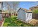 Backyard features a well-maintained shed and deck with green grass at 11908 W Aqueduct Dr, Littleton, CO 80127