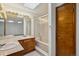 Bright bathroom features a double vanity, large mirror, and glass shower doors at 11908 W Aqueduct Dr, Littleton, CO 80127