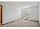 Carpeted bedroom with neutral walls, a window, and baseboard trim at 11908 W Aqueduct Dr, Littleton, CO 80127