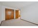 Carpeted bedroom features a closet with bi-fold doors at 11908 W Aqueduct Dr, Littleton, CO 80127