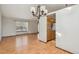 Spacious open floor plan with laminate flooring connecting dining area to the kitchen at 11908 W Aqueduct Dr, Littleton, CO 80127
