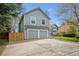 Inviting two-story home with attached two-car garage, spacious driveway and manicured yard at 11908 W Aqueduct Dr, Littleton, CO 80127