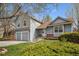Two-story home featuring an attached two-car garage, well maintained lawn and manicured bushes at 11908 W Aqueduct Dr, Littleton, CO 80127