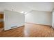 Bright living room featuring laminate floors and skylights at 11908 W Aqueduct Dr, Littleton, CO 80127
