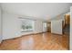 Spacious living room boasts beautiful laminate flooring, bright windows, and neutral paint throughout at 11908 W Aqueduct Dr, Littleton, CO 80127