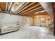 Unfinished basement featuring exposed wood ceiling, concrete walls, and natural light at 444 S Larkspur Dr, Castle Rock, CO 80104