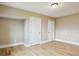 Bedroom featuring hardwood floors, two white doors, baseboard trim and fresh neutral paint at 444 S Larkspur Dr, Castle Rock, CO 80104
