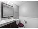 Well-lit half bath featuring a modern vanity, mirror, and neutral color scheme at 8901 Field St # 76, Broomfield, CO 80021