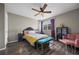 Cozy bedroom with a ceiling fan, wood floors, and vibrant decor at 8901 Field St # 76, Broomfield, CO 80021