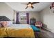 Cozy bedroom with a ceiling fan, wood floors, and vibrant decor at 8901 Field St # 76, Broomfield, CO 80021