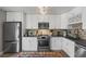 Modern kitchen featuring white cabinetry, stainless steel appliances, and stylish backsplash at 8901 Field St # 76, Broomfield, CO 80021