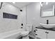 Updated bathroom features modern sink, hexagon tile inset, and marble-look shower at 951 E 10Th Ave, Broomfield, CO 80020