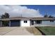 Charming single story home featuring a dark blue garage door and modern front door at 951 E 10Th Ave, Broomfield, CO 80020