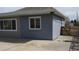 Angle view of house exterior showing the wall featuring grey painted brick next to the cement driveway at 951 E 10Th Ave, Broomfield, CO 80020