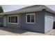 Angle view of the house exterior showcasing grey painted brick and siding, along with the cement driveway at 951 E 10Th Ave, Broomfield, CO 80020