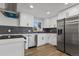 Stylish kitchen with stainless steel appliances and modern black, gray backsplash at 951 E 10Th Ave, Broomfield, CO 80020