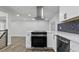 Contemporary kitchen with stainless steel appliances, white cabinets, and a modern range hood at 951 E 10Th Ave, Broomfield, CO 80020