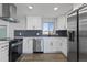 Well-equipped kitchen with stainless steel appliances and sleek white cabinetry at 951 E 10Th Ave, Broomfield, CO 80020