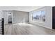 Bright living room with large windows, modern wood accent wall, and luxury vinyl flooring at 951 E 10Th Ave, Broomfield, CO 80020