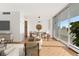 Virtually staged dining area with hardwood floors and access to balcony at 1250 N Humboldt St # 1002, Denver, CO 80218