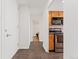 Entryway with dark wood floors, view of bathroom and kitchen at 1250 N Humboldt St # 1002, Denver, CO 80218