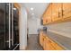 Modern kitchen with wood cabinets and dark appliances at 1250 N Humboldt St # 1002, Denver, CO 80218