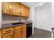 View of kitchen sink and dishwasher, wood cabinets at 1250 N Humboldt St # 1002, Denver, CO 80218