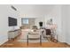 Bright living room with hardwood floors and sliding glass door access to a balcony at 1250 N Humboldt St # 1002, Denver, CO 80218