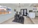 Bright dining room with modern light fixtures, a sleek table, and access to the kitchen at 1005 Elmer Dr, Northglenn, CO 80233