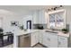 Modern kitchen featuring white cabinets, stainless steel appliances, and a quartz countertop island at 1005 Elmer Dr, Northglenn, CO 80233